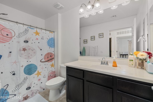 bathroom featuring tile patterned flooring, a shower with curtain, vanity, and toilet