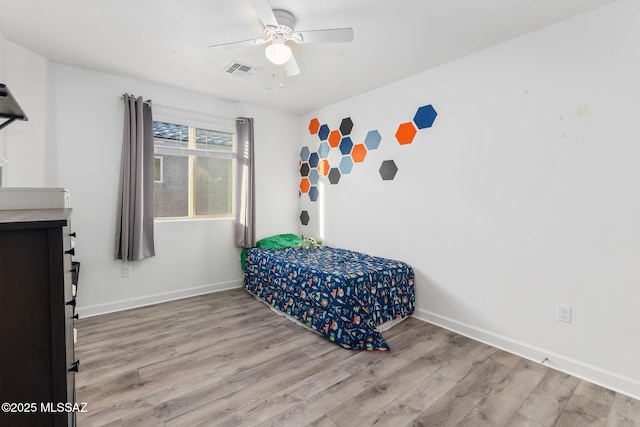 bedroom with ceiling fan and light hardwood / wood-style flooring