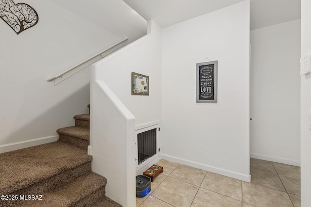 stairway with tile patterned floors