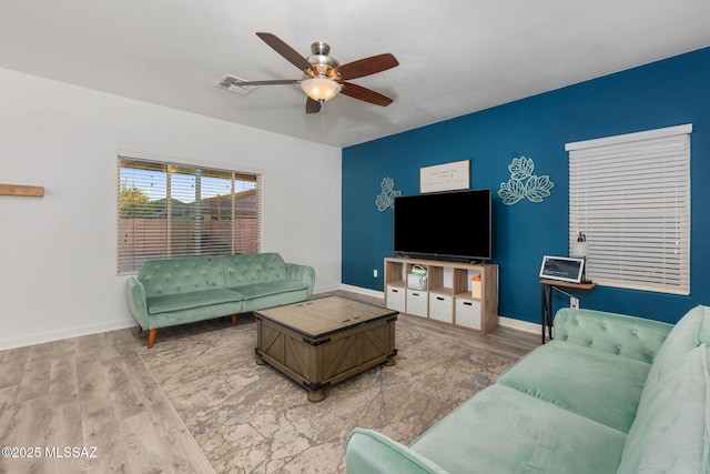 living room featuring hardwood / wood-style flooring and ceiling fan