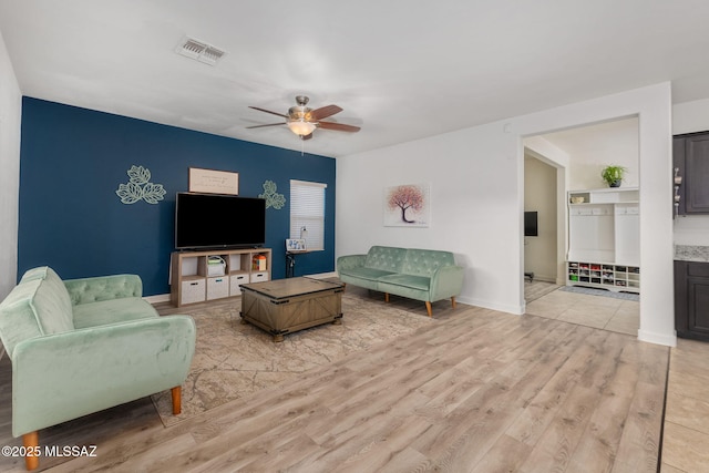 living room featuring ceiling fan and light hardwood / wood-style floors