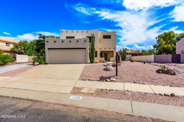 pueblo-style home with a garage