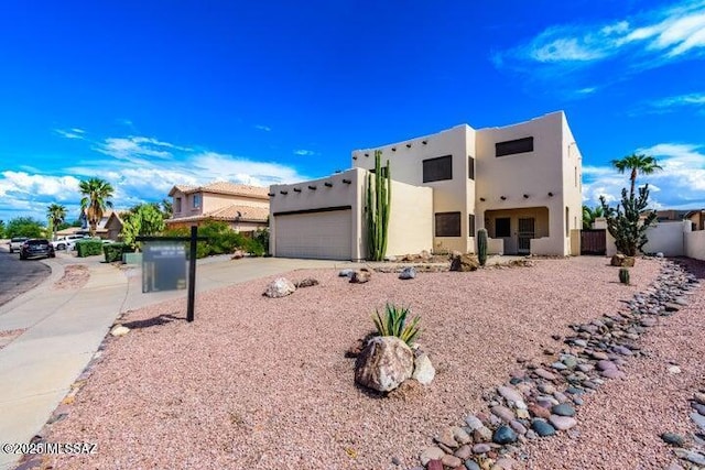 pueblo revival-style home with a garage