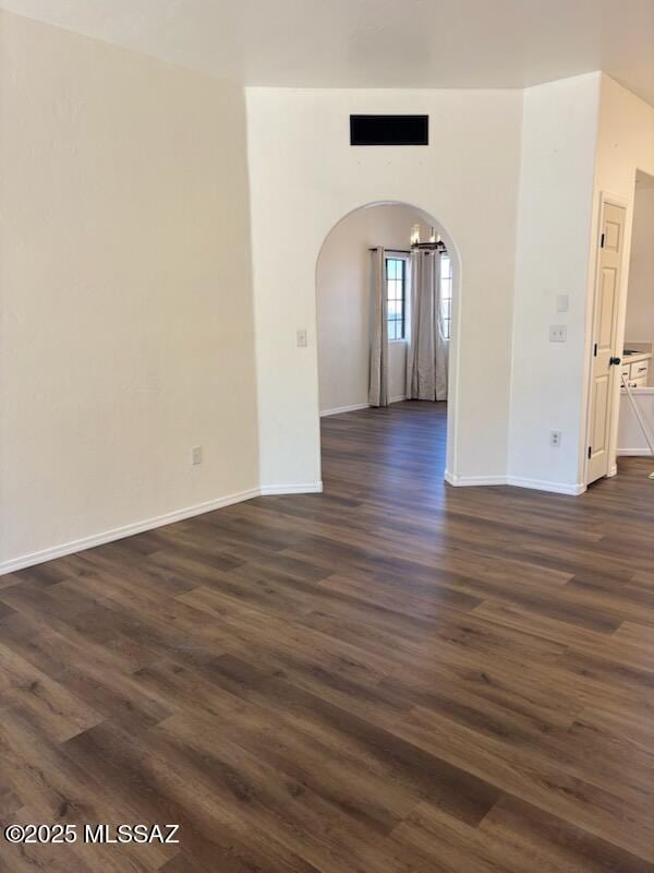 empty room with dark hardwood / wood-style floors