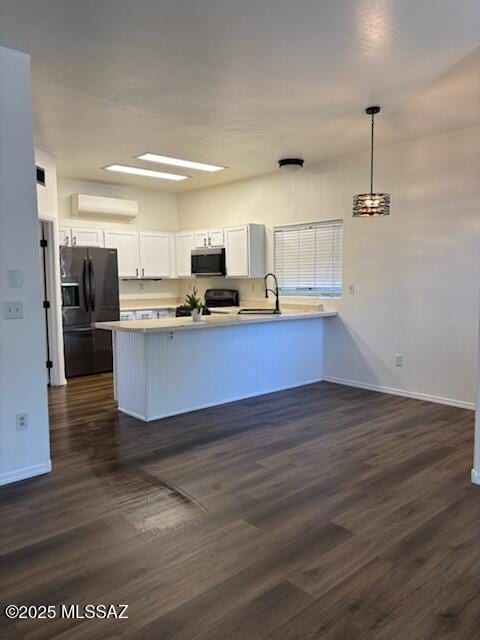 kitchen with white cabinets, decorative light fixtures, kitchen peninsula, and black appliances