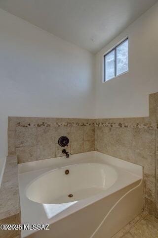 bathroom featuring a bath, vaulted ceiling, and tile patterned floors