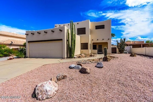 pueblo-style house with a garage