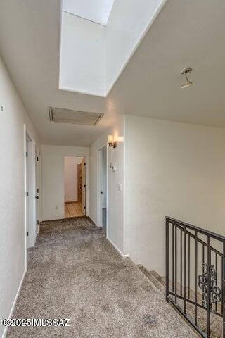 carpeted spare room featuring a skylight