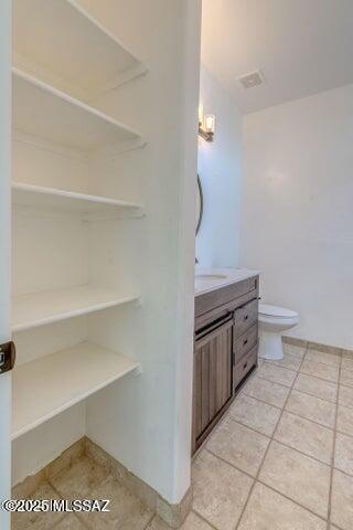 bathroom with tile patterned floors, vanity, and toilet