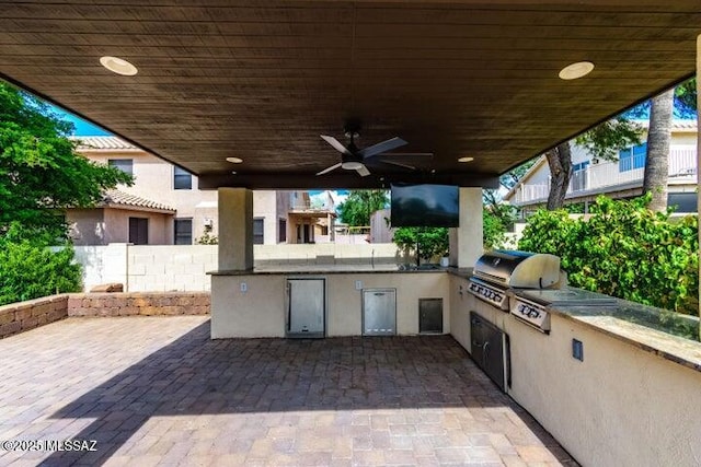 view of patio / terrace featuring a grill, ceiling fan, and an outdoor kitchen