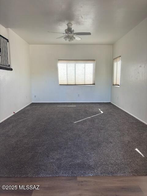 empty room featuring ceiling fan and dark hardwood / wood-style floors