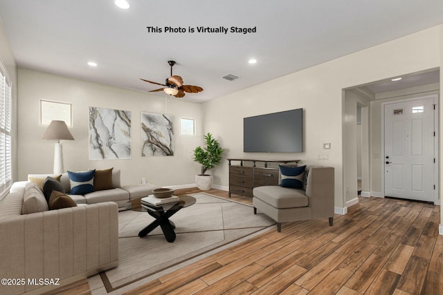 living room with hardwood / wood-style floors, a healthy amount of sunlight, and ceiling fan