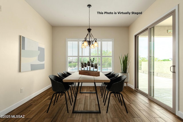 dining room with an inviting chandelier, a healthy amount of sunlight, and hardwood / wood-style flooring