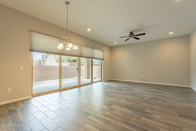 unfurnished room with ceiling fan with notable chandelier