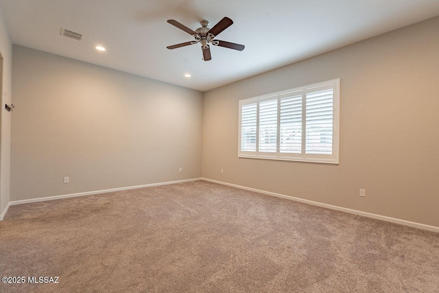 unfurnished room with ceiling fan and carpet floors