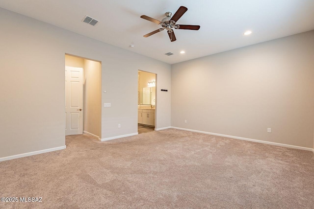 unfurnished bedroom featuring ceiling fan, connected bathroom, and light colored carpet