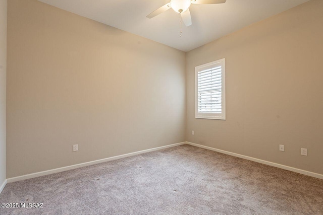 unfurnished room with ceiling fan and carpet