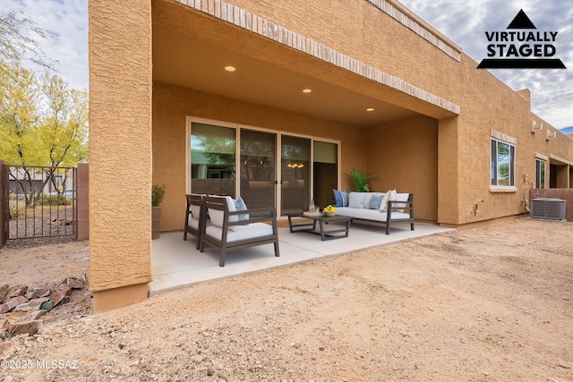 rear view of house featuring central AC, an outdoor living space, and a patio