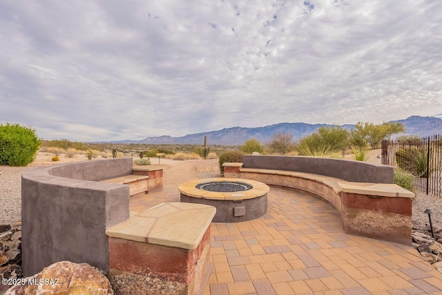 view of patio featuring a mountain view and a fire pit