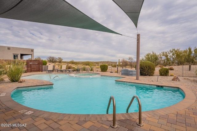 view of pool featuring a hot tub and a patio