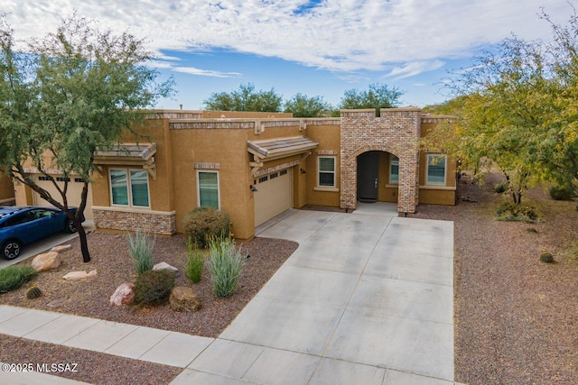 pueblo-style home featuring a garage