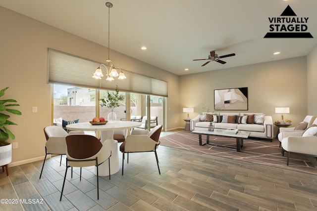 dining room featuring ceiling fan with notable chandelier