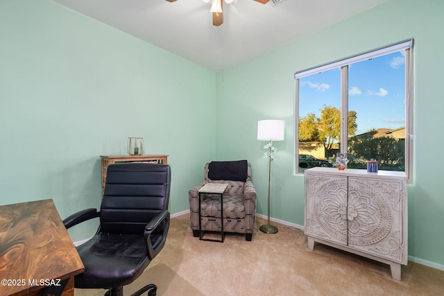 carpeted office space featuring ceiling fan