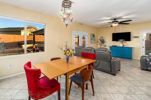 dining room with ceiling fan, light tile patterned floors, and french doors