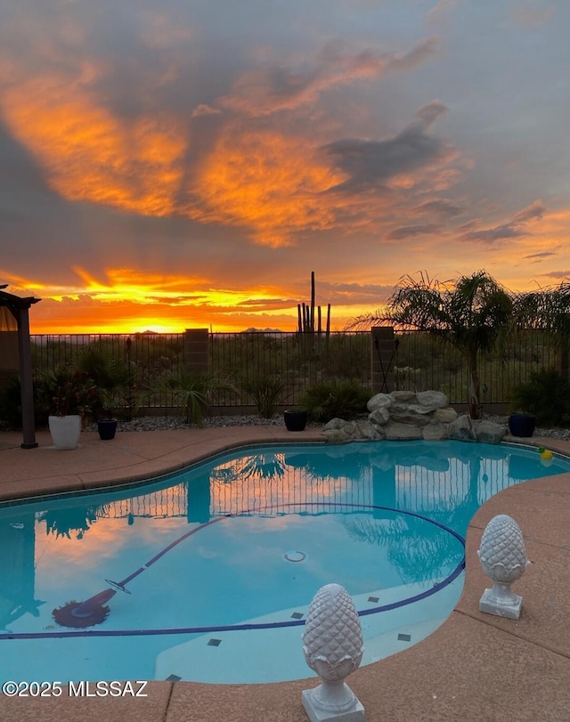 view of pool at dusk