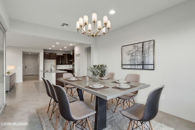 dining area with a chandelier and sink