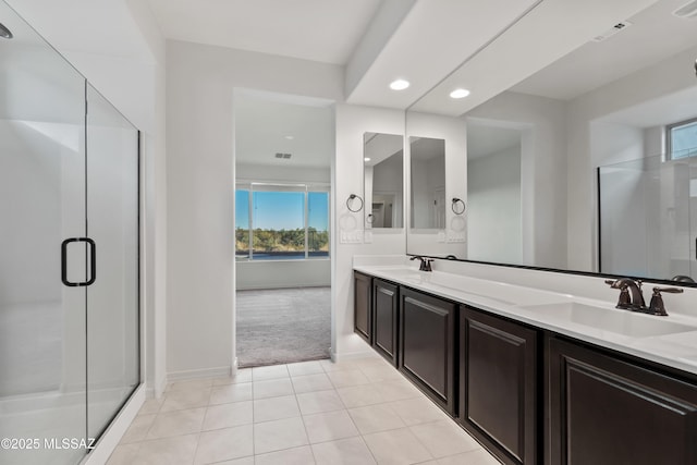 bathroom with tile patterned floors, vanity, and an enclosed shower