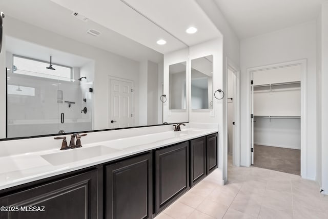 bathroom featuring tile patterned flooring, vanity, and a shower with door