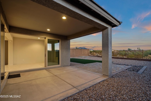 view of patio terrace at dusk