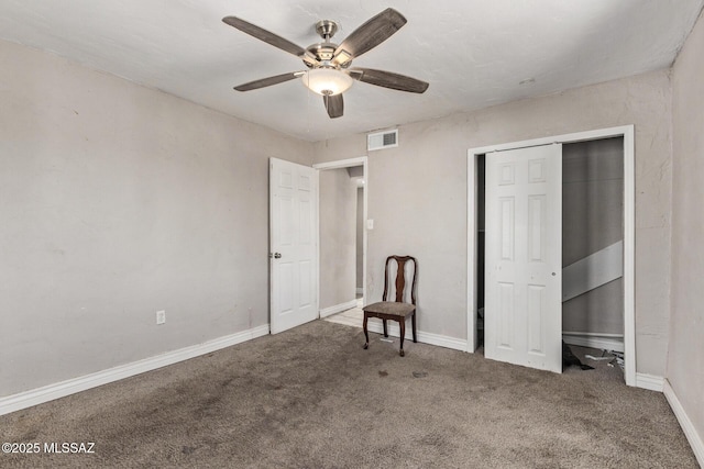 unfurnished bedroom featuring carpet, ceiling fan, and a closet