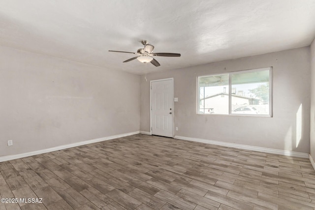 spare room with light hardwood / wood-style floors and ceiling fan