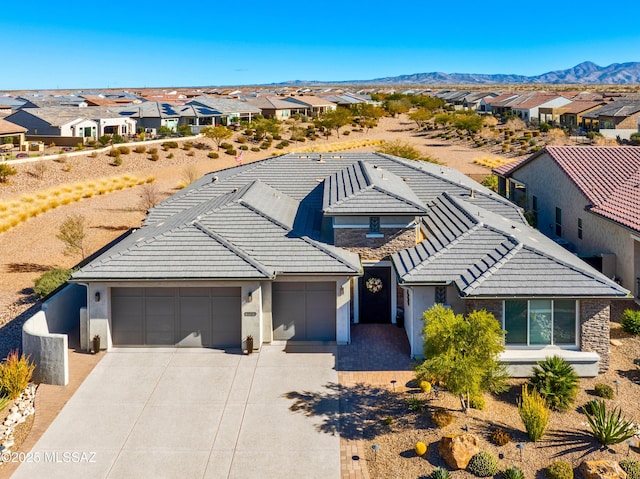 view of front of home featuring a mountain view and a garage