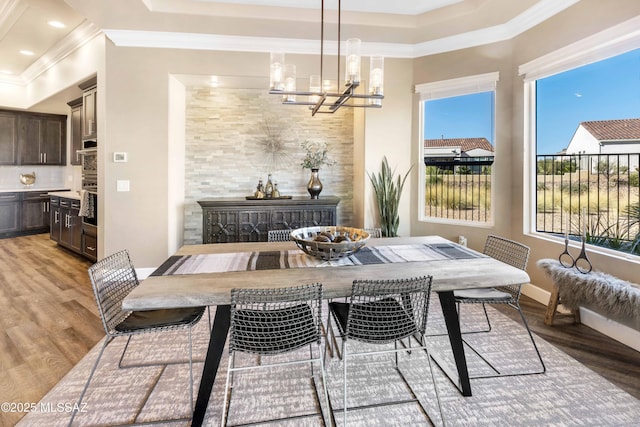 dining area featuring a chandelier, hardwood / wood-style flooring, and a healthy amount of sunlight