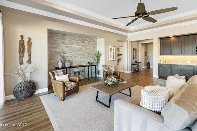 living room with hardwood / wood-style flooring, ceiling fan, and ornamental molding