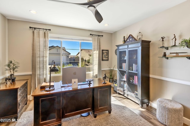 home office featuring light hardwood / wood-style flooring and ceiling fan