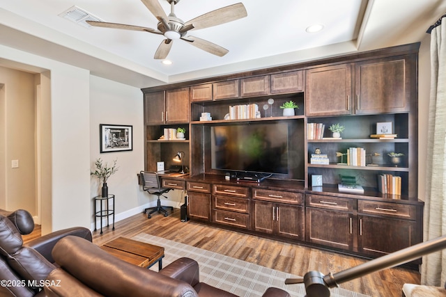 living room featuring ceiling fan and light hardwood / wood-style flooring