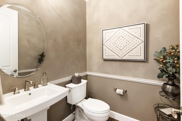 bathroom featuring sink and toilet