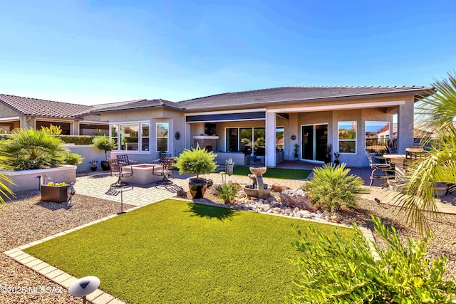 back of house featuring a patio and an outdoor fire pit