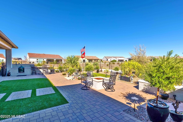 view of patio with a bar and a fire pit