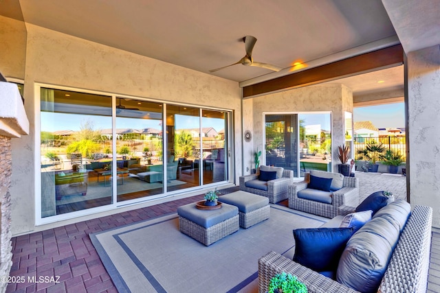 view of patio with an outdoor living space and ceiling fan