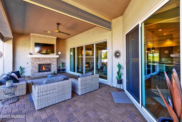 view of patio featuring an outdoor living space with a fireplace and ceiling fan