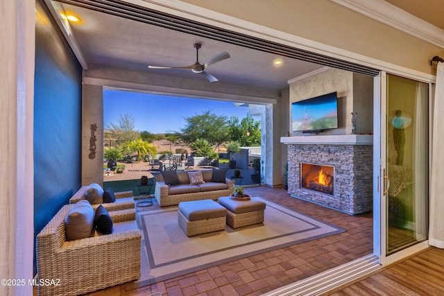 home theater room featuring ceiling fan, crown molding, and an outdoor stone fireplace