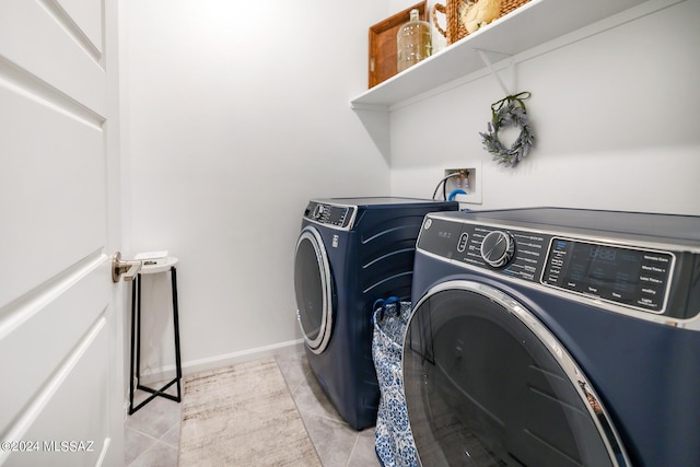 washroom with independent washer and dryer and light tile patterned floors