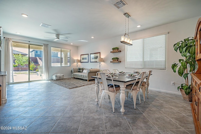 tiled dining area featuring ceiling fan