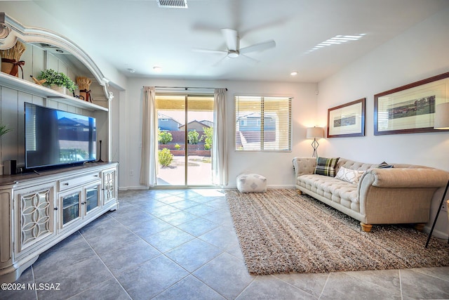 tiled living room featuring ceiling fan