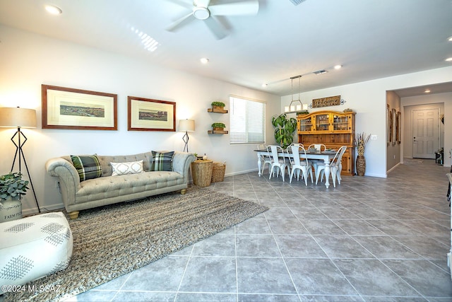 tiled living room featuring ceiling fan